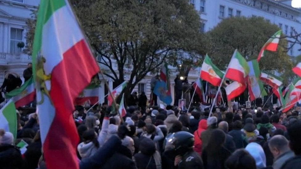 Protester climbs on to balcony of Iranian embassy in London