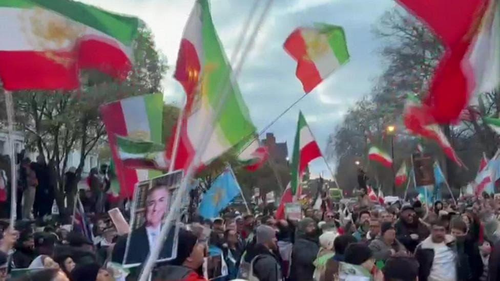Protester climbs onto balcony of Iranian embassy in London