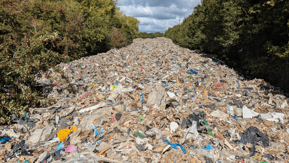 Man arrested over fly-tipped mountain of waste