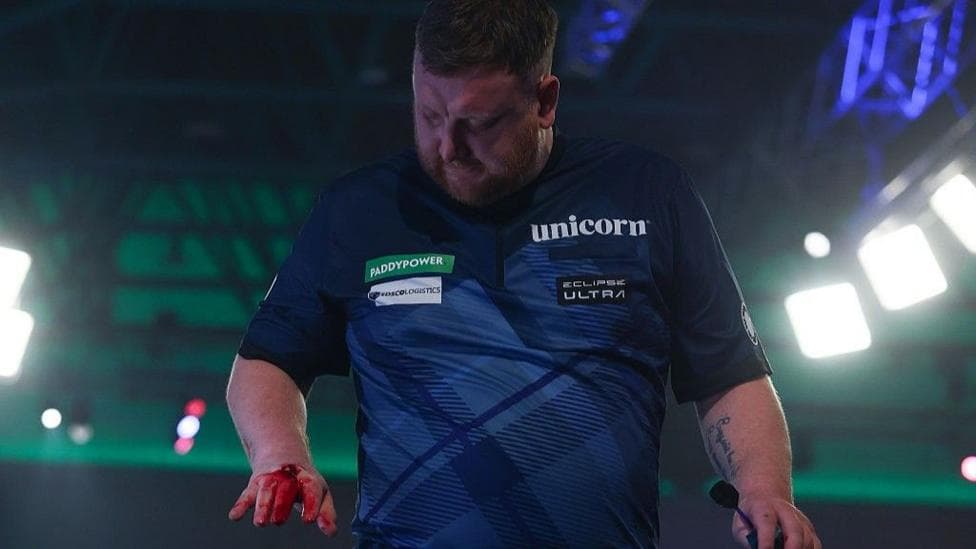 Darts star Menzies apologies for punching table after five-set defeat